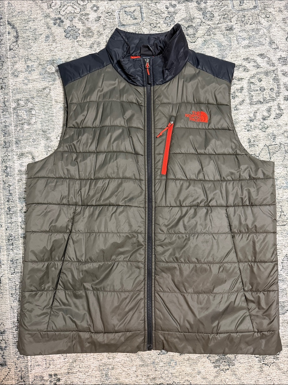 The North Face Men's Olive Quilted Vest with Navy Shoulders and Orange Accents